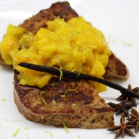 Image of a couple pieces of cardamom french toast topped with a spoonful of the mango lime chutney