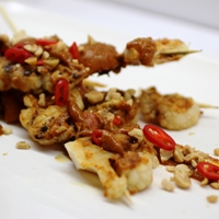 Image of roasted cauliflower skewers with a smoky peanut and apricot sauce.