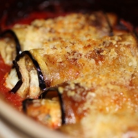 Image of Eggplant Involtini Stewed in Tomato Sauce.