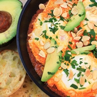 Image of Spanish Eggs with Oven Roasted Tomatoes and Almonds