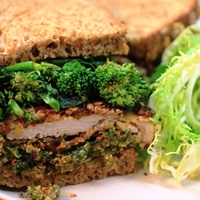 Image of oat crusted turkey cutlet and rapini sandwich.