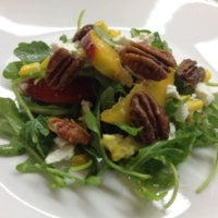Image of Ontario peach and arugula salad with maple ginger pecans.