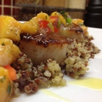Image of seared scallops with a grilled peach mojito salsa.