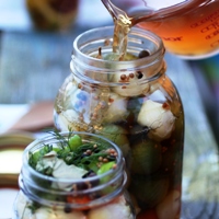 Image of a jar of pickles being prepared