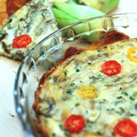 Image of a baking dish of the caramelized onion & artichoke quiche