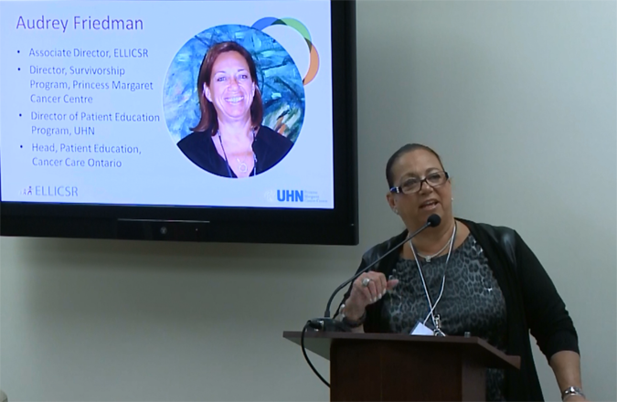 Audrey Friedman at the podium, welcoming participants