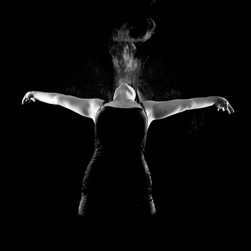 Image of woman dancing in a dark room