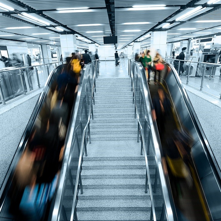 Image of people crowded on the escalator and no one on the stairs