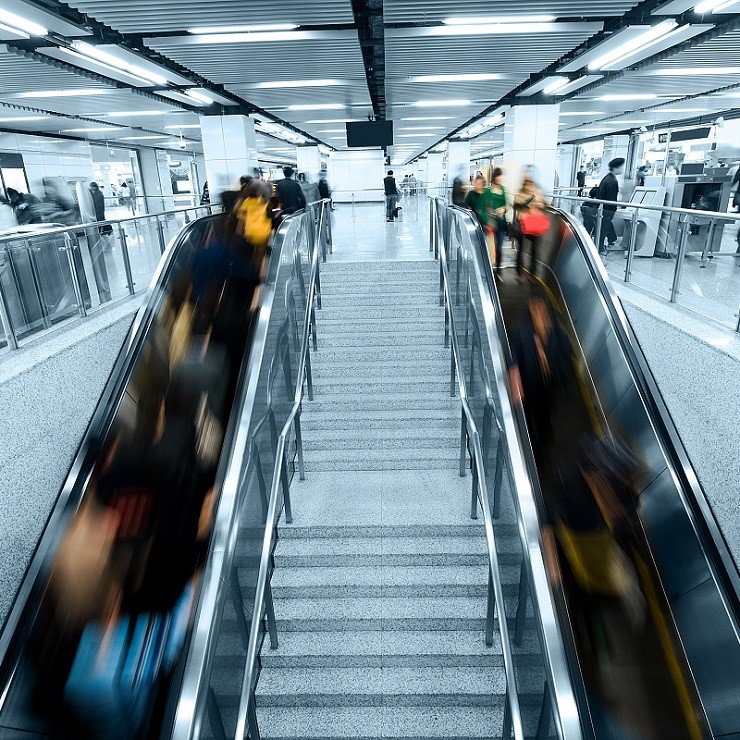 Image of people crowded on the escalator and no one on the stairs