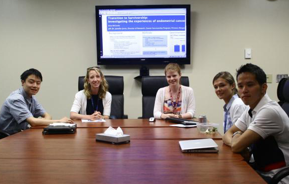 Image of a group of students sitting in the ELLICSR boardroom