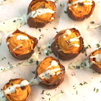 Image of Loaded Sweet Potato with a Garlic Gouda Sauce.
