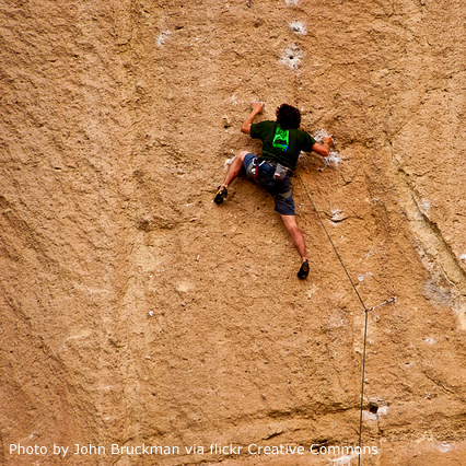 image of a man climbing a rock wall